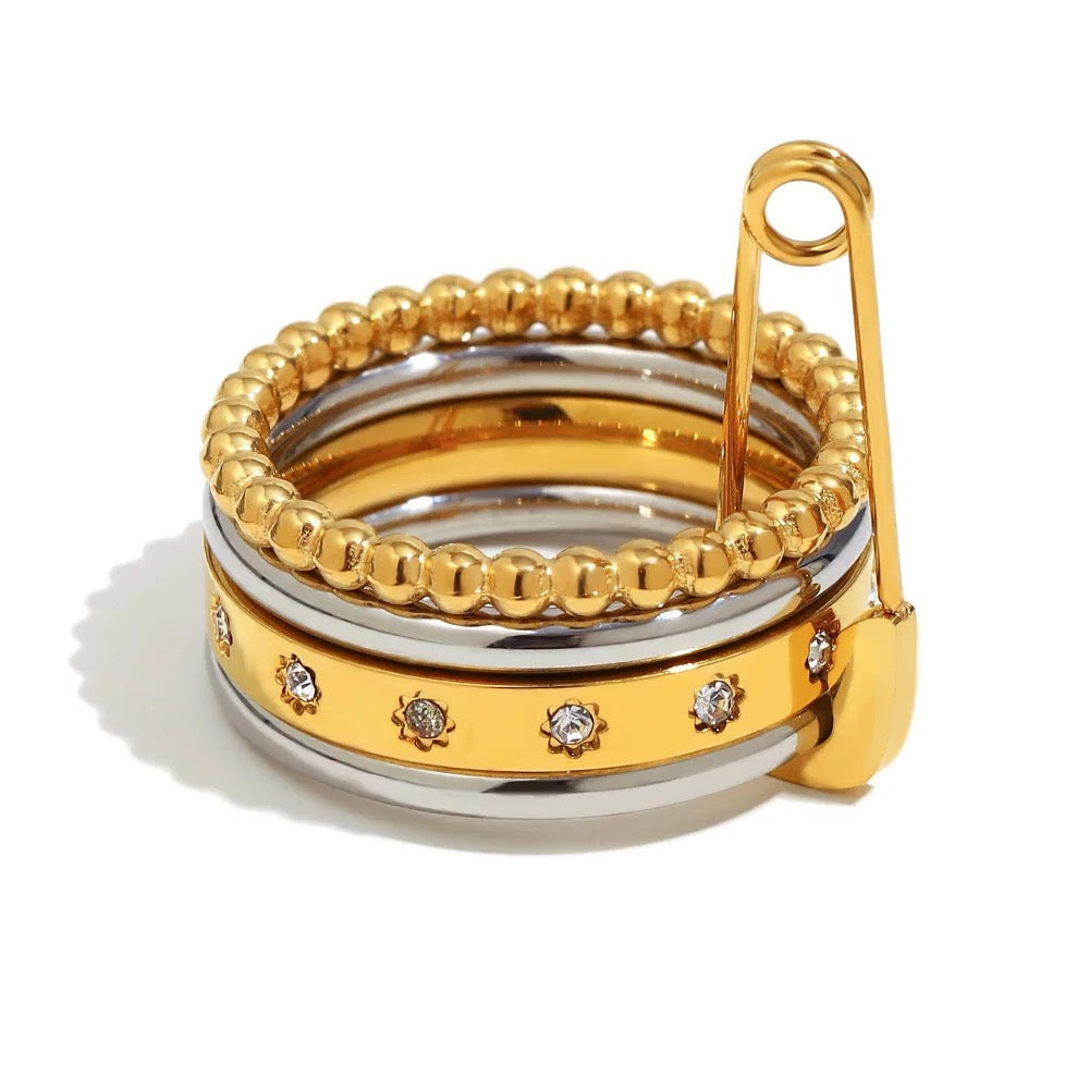 Set of gold and silver rings with a beaded design on a white background