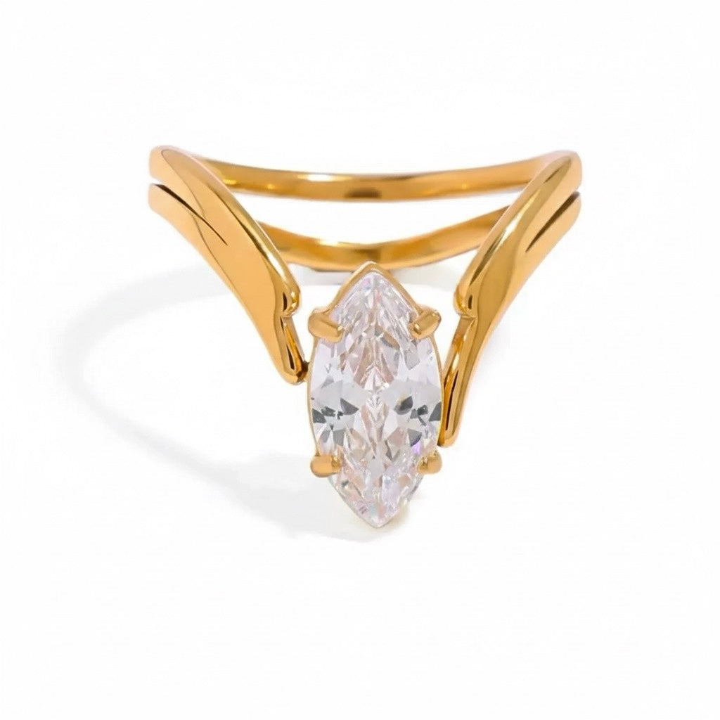 Gold ring with a marquise-shaped diamond on a white background