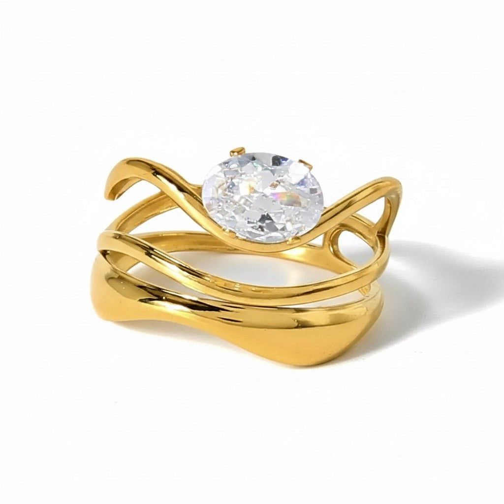 Gold ring with a clear gemstone on a white background