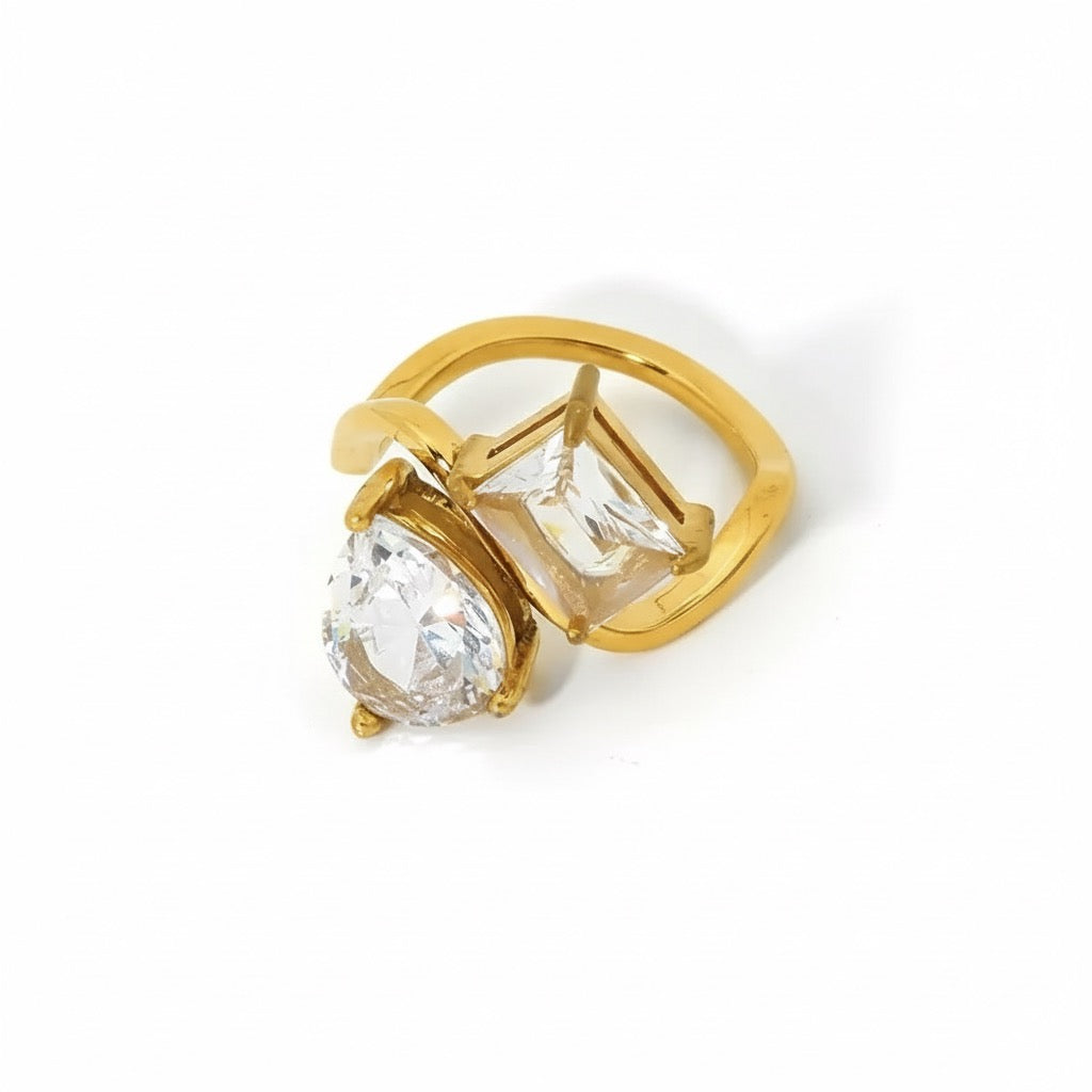 Gold ring with clear gemstone on a white background