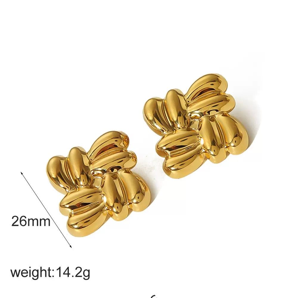 Pair of gold earrings with measurements on a white background