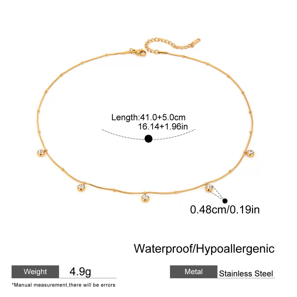 Gold necklace with measurement details on a white background