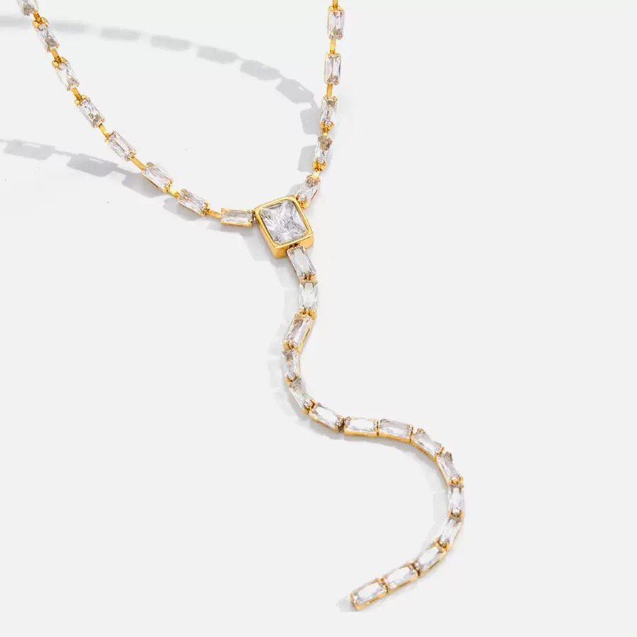 Gold and clear beaded necklace on a white background