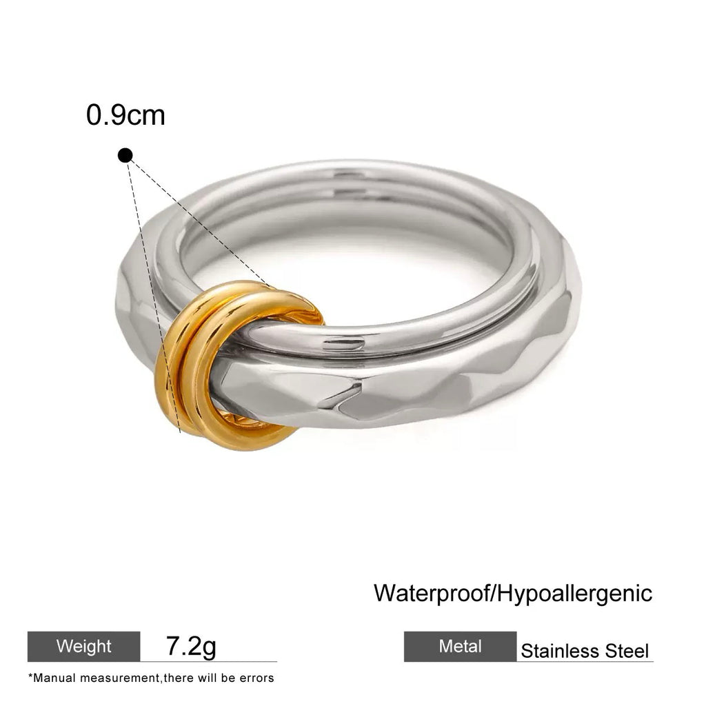 Silver and gold ring with measurement details on a white background