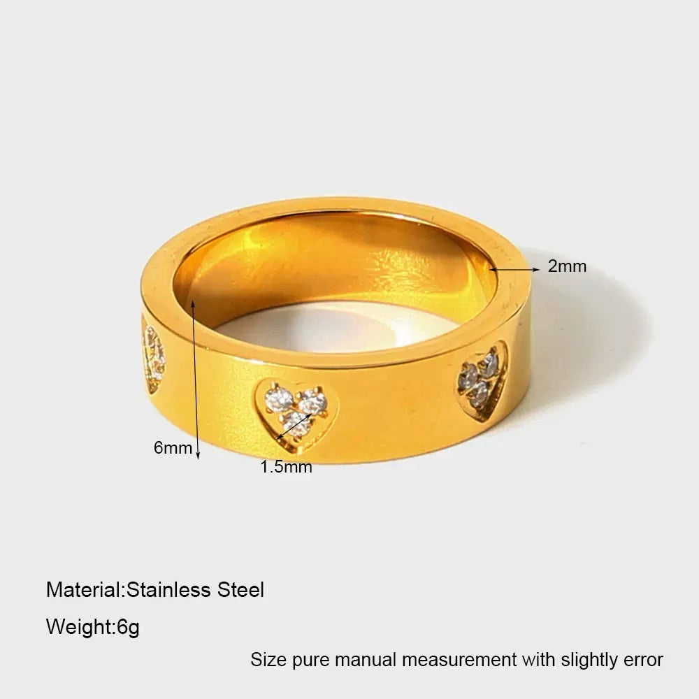 Gold ring with heart designs and measurements on a white background