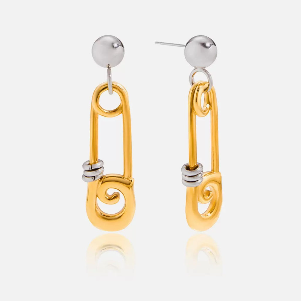 Gold and silver earrings on a white background