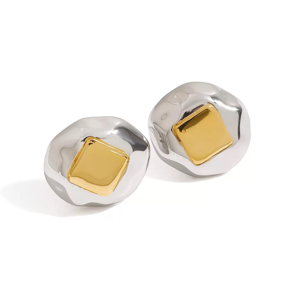Pair of silver and gold earrings on a white background