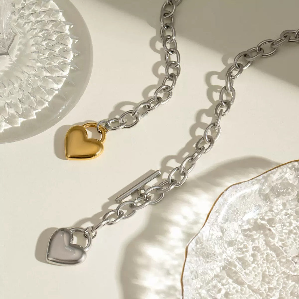 Silver chain with heart-shaped pendants on a light background
