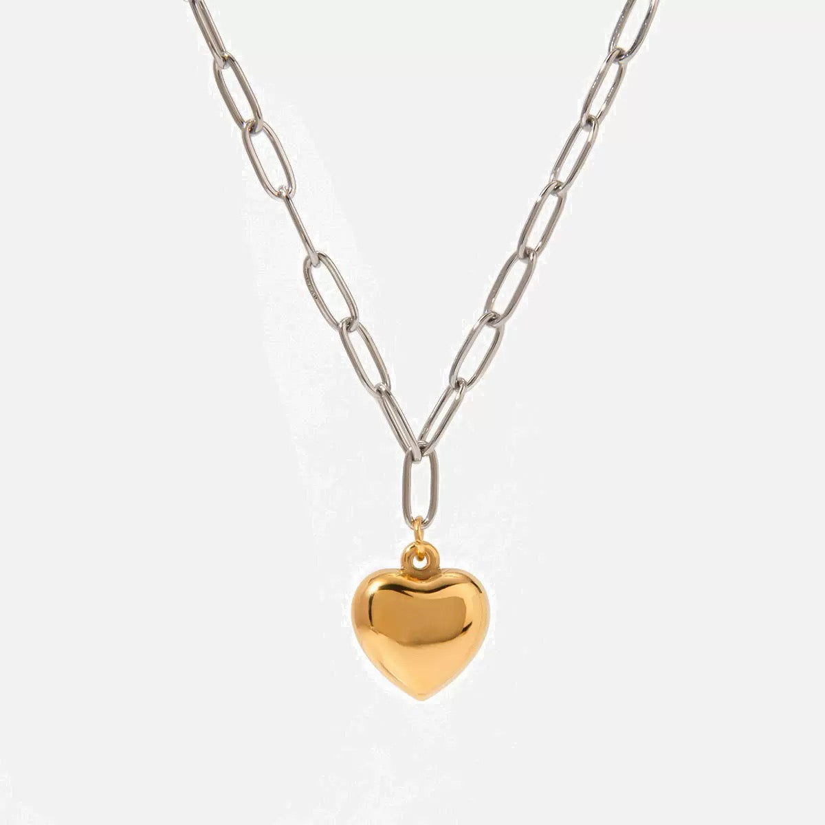 Necklace with a gold heart pendant on a light gray background