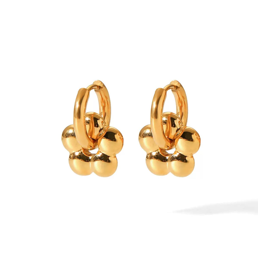 Pair of gold hoop earrings with spherical accents on a white background