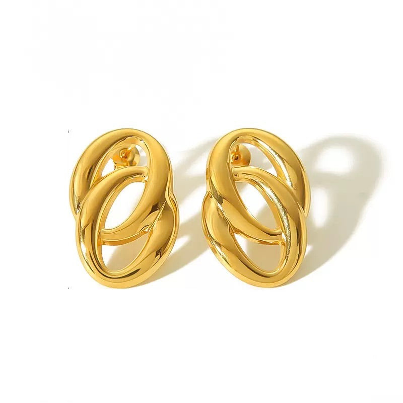 Pair of gold earrings on a white background