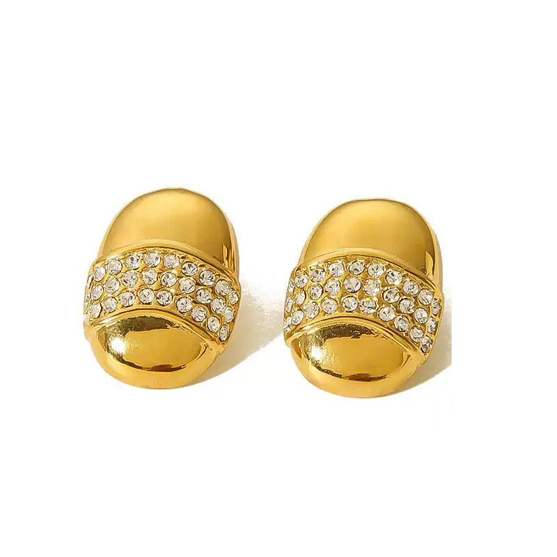 Gold earrings with crystal embellishments on a white background