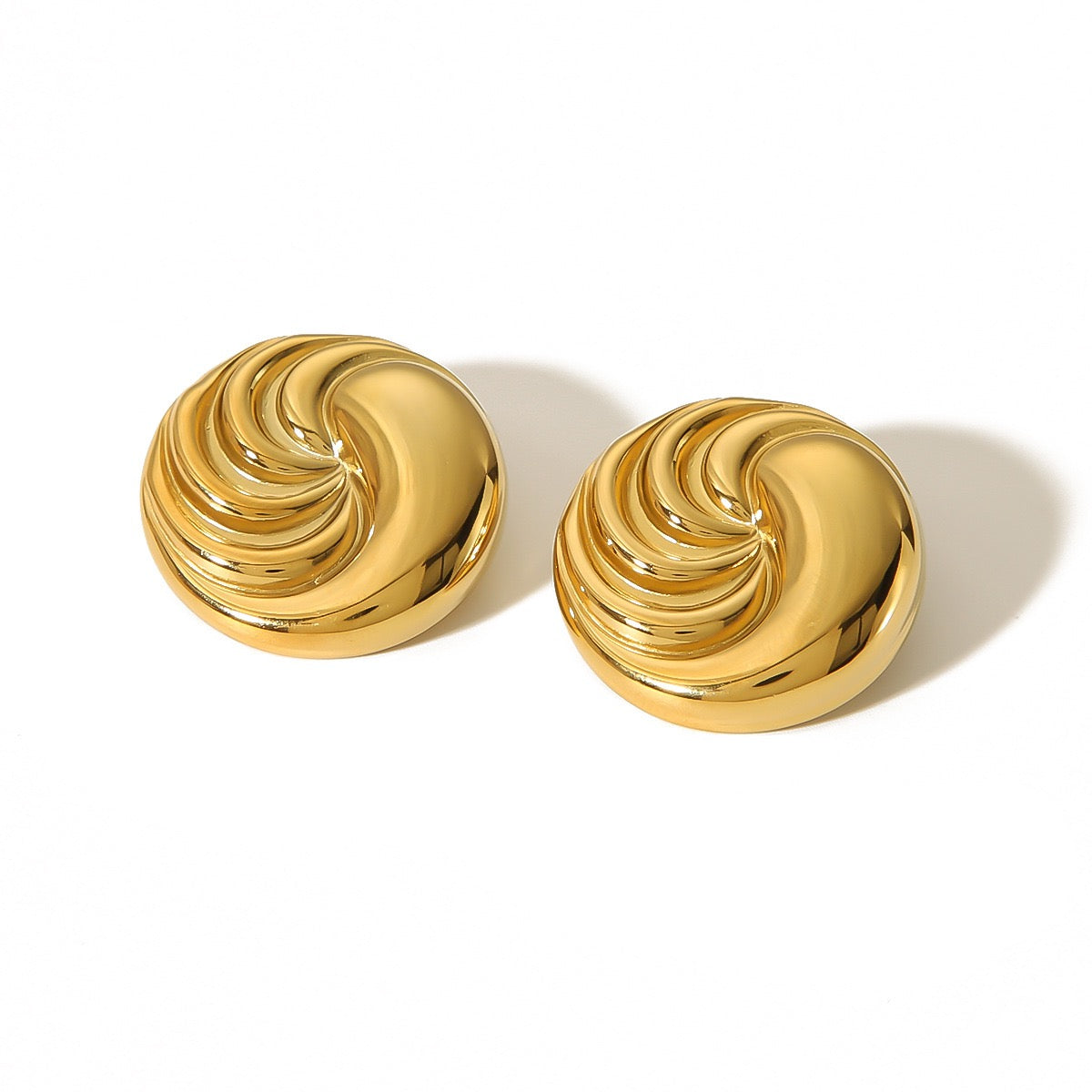 Pair of gold spiral earrings on a white background