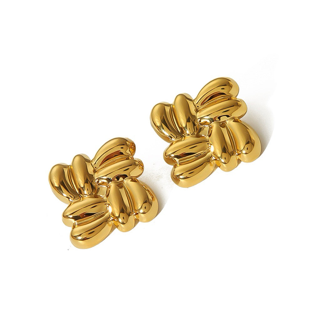 Pair of gold earrings on a white background