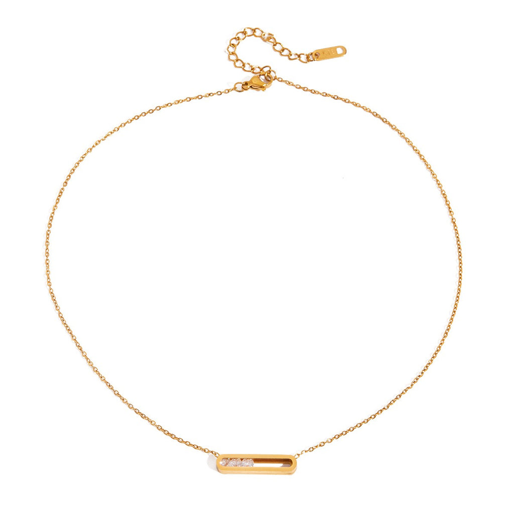 Gold necklace with a bar pendant on a white background