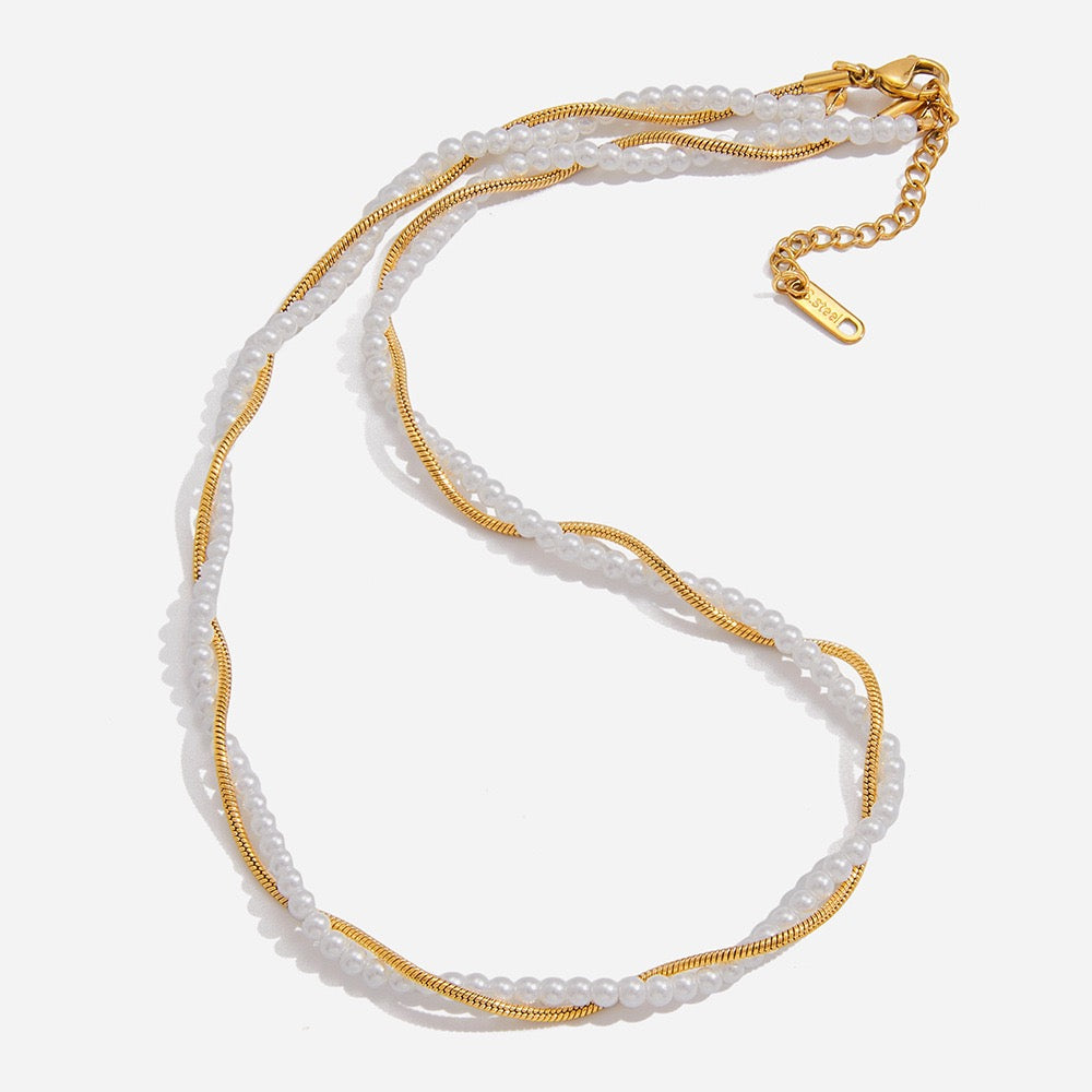 Necklace with white beads and gold chain on a white background