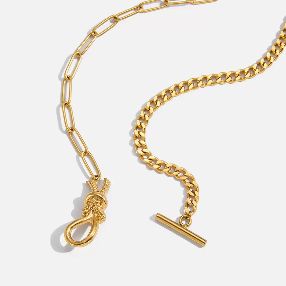 Gold chain necklace with OT clasp and toggle on a white background