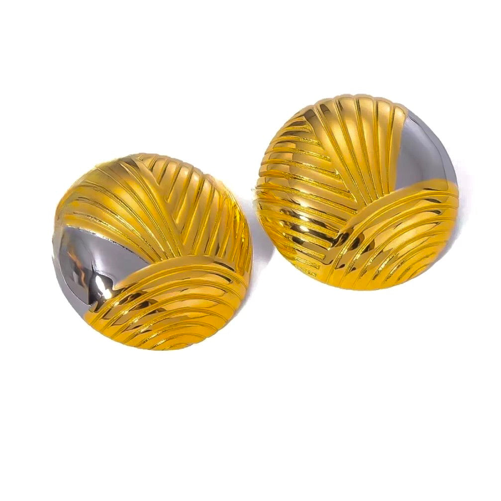 Pair of gold and silver earrings on a white background