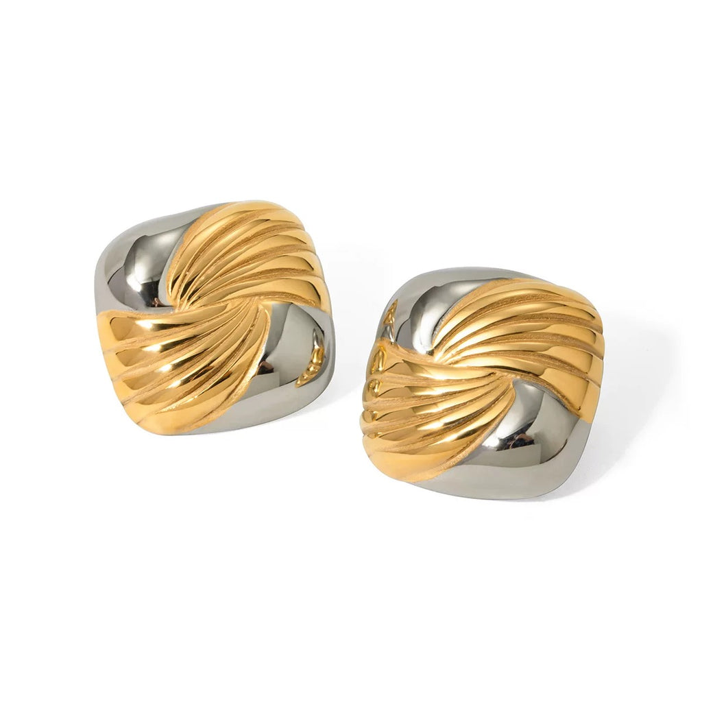 Pair of gold and silver earrings on a white background