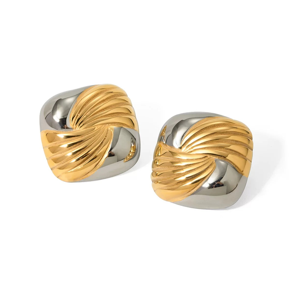 Pair of gold and silver earrings on a white background