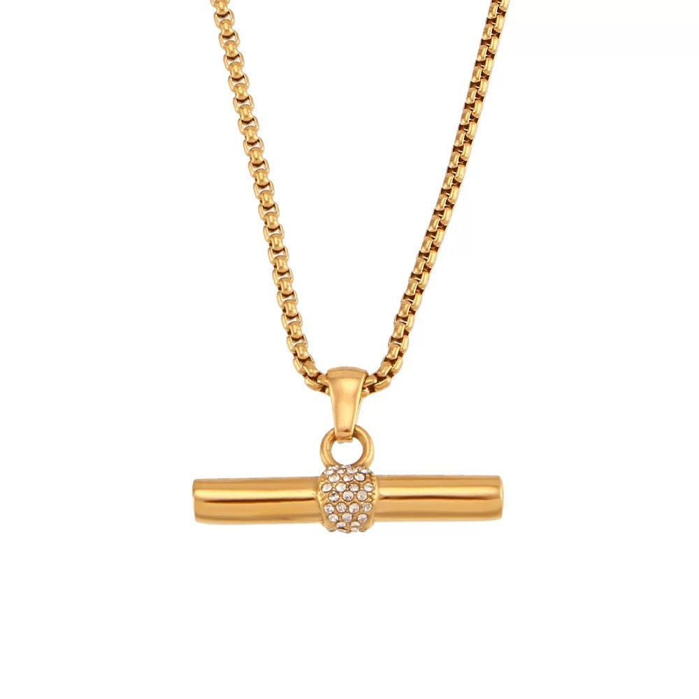 Gold necklace with a unique pendant on a white background