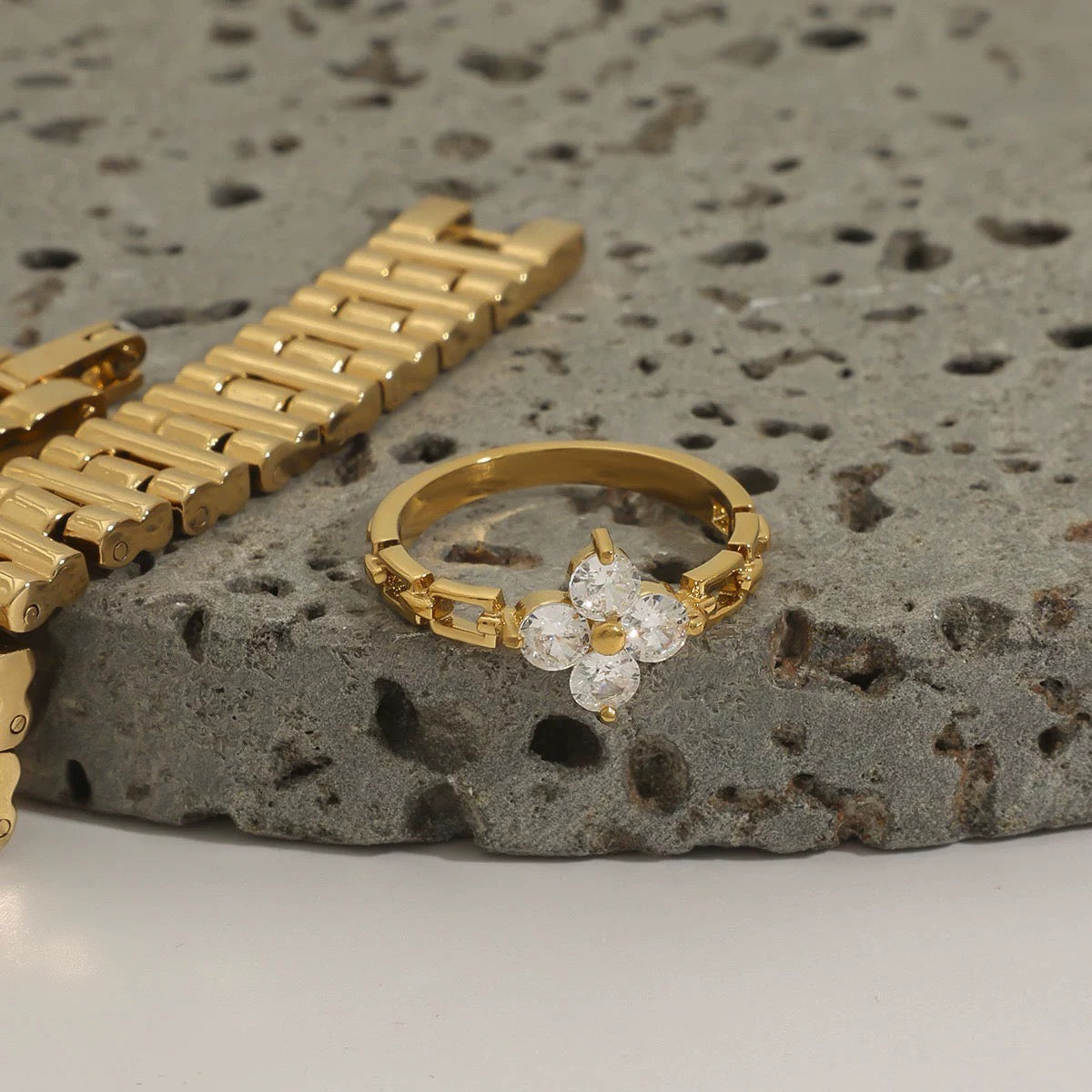 Gold ring with diamonds on a textured stone surface