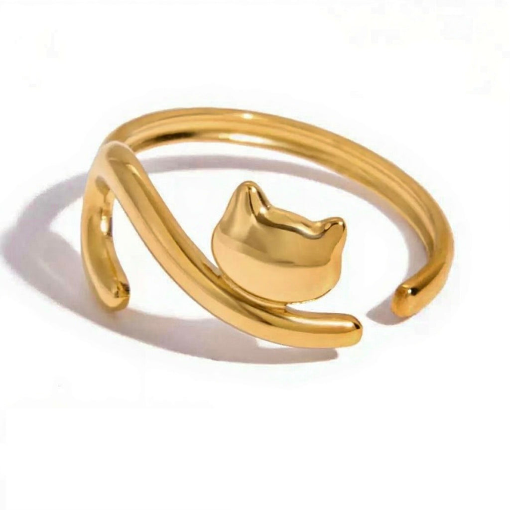 Gold cat-shaped ring on a white background