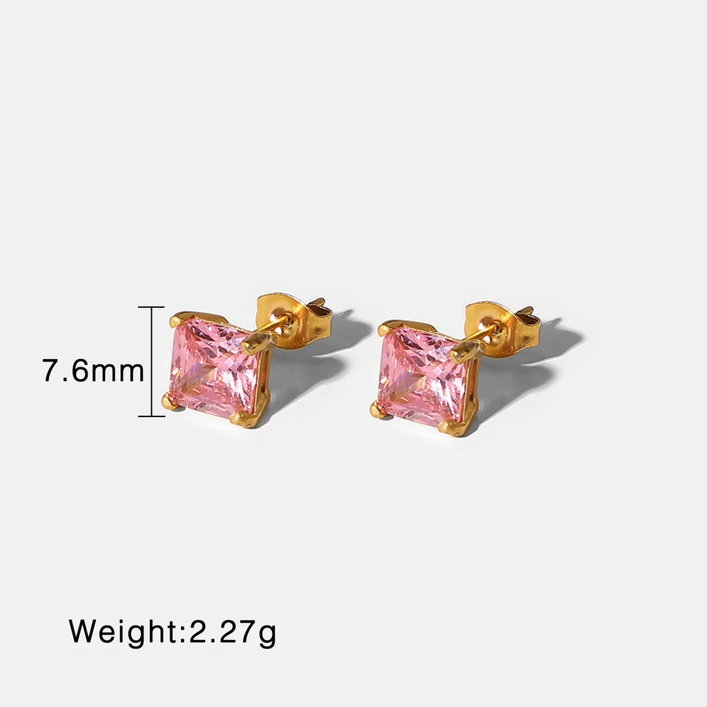 Gold earrings with pink gemstones on a white background, showing measurements and weight.