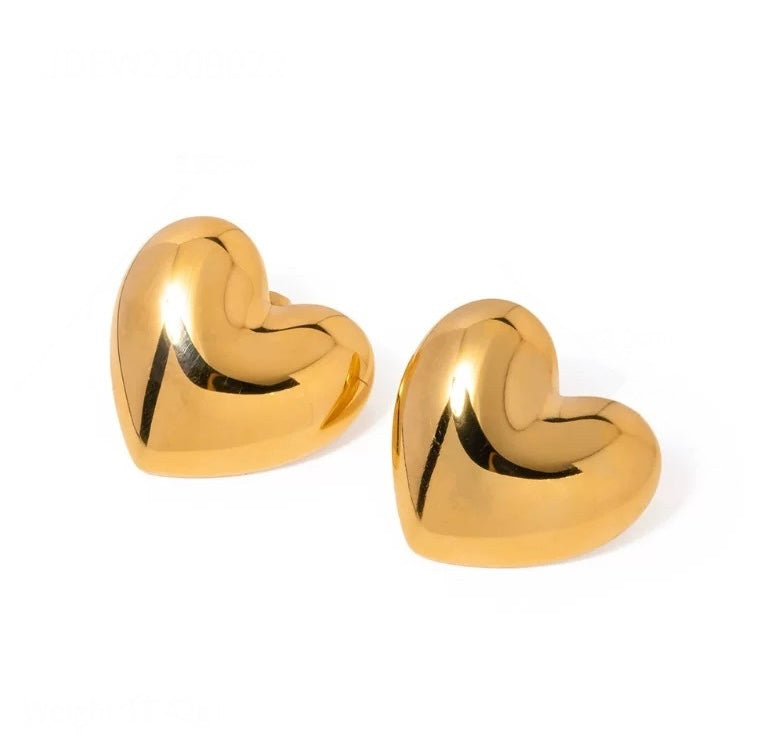 Gold heart-shaped earrings on a white background