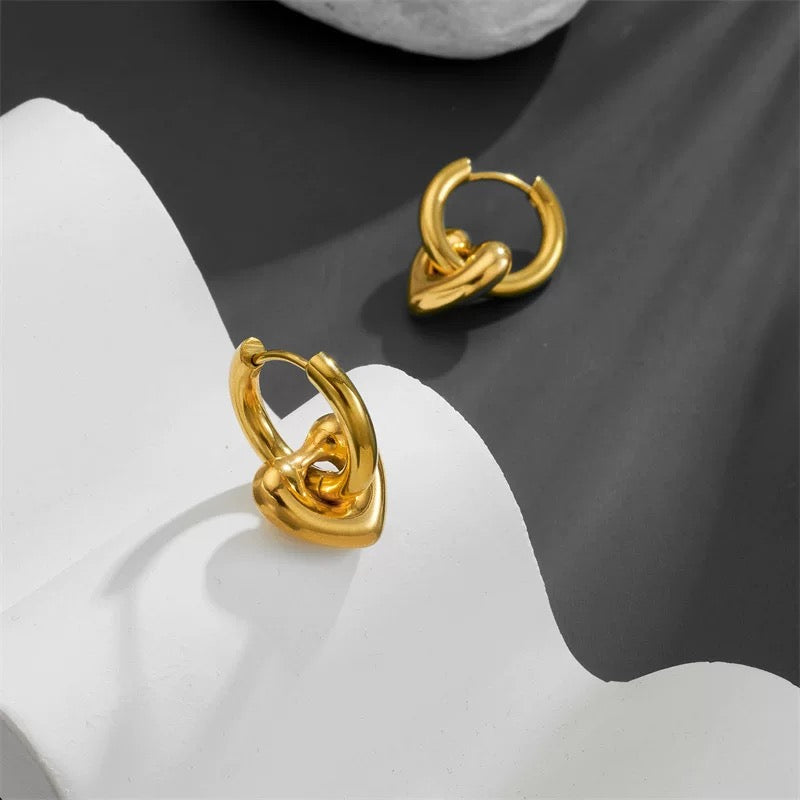 Pair of gold hoop earrings on a white and gray background