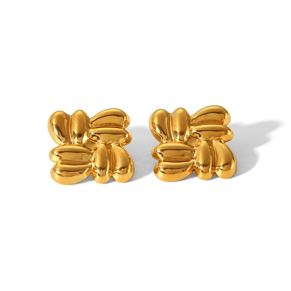 Pair of gold butterfly-shaped earrings on a white background