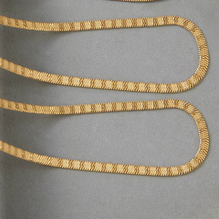 Gold chain on a gray background