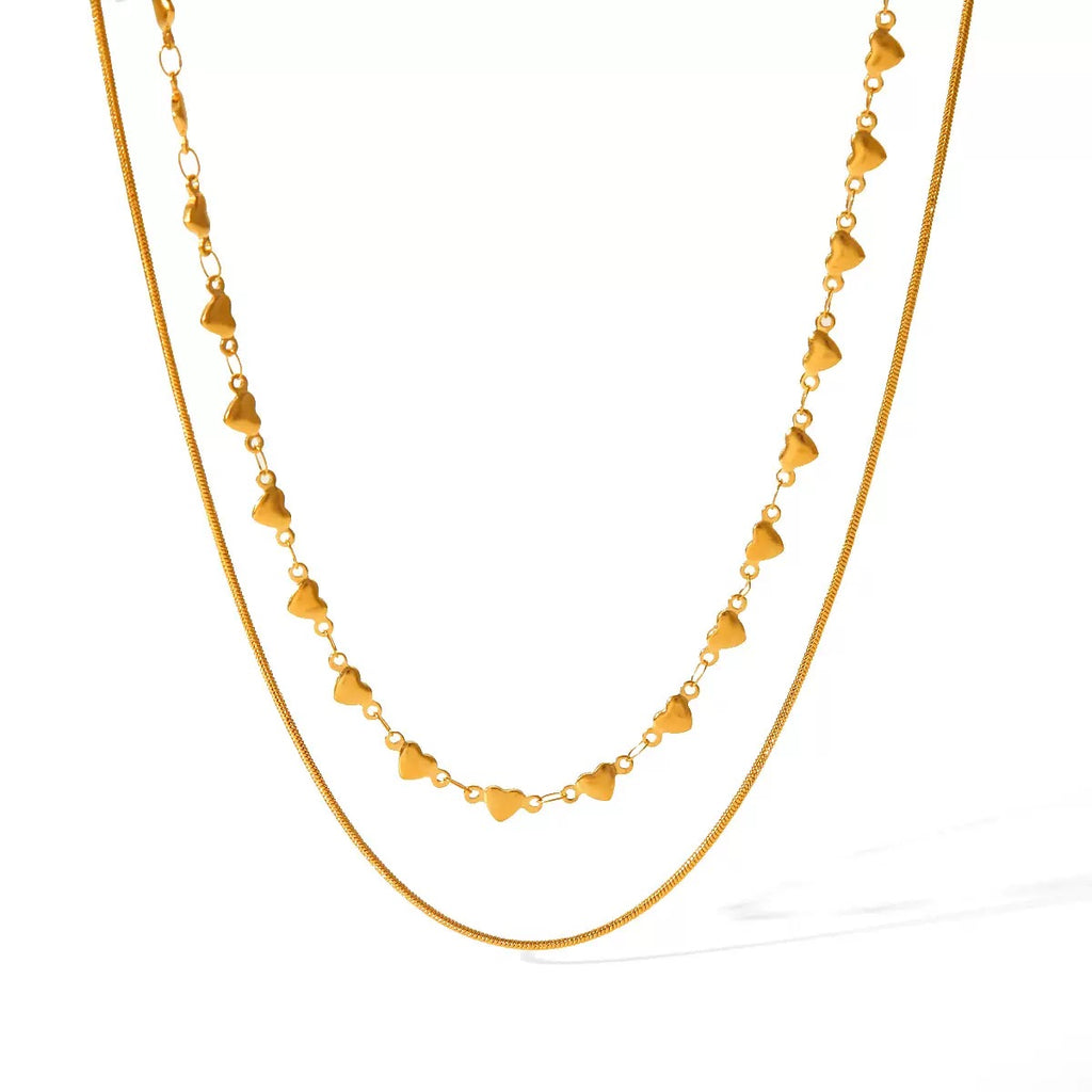 Gold necklace with heart-shaped links on a white background