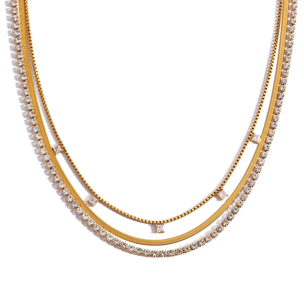 Two gold necklaces with diamond accents on a white background